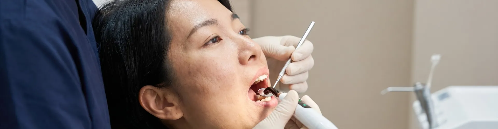 Dentist using dental tools to examine a patient.