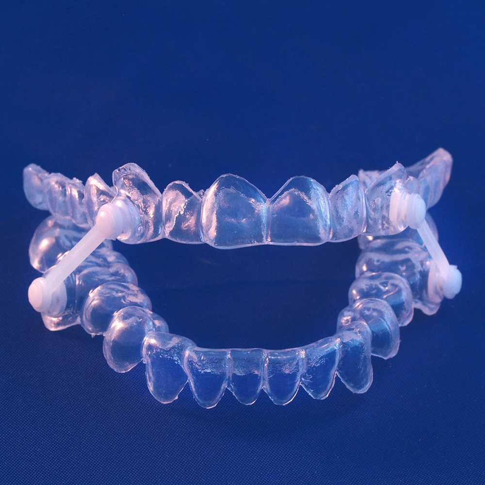 Invisalign-shaped sleep apnea appliance holding upper and lower jaw closed, blue background.