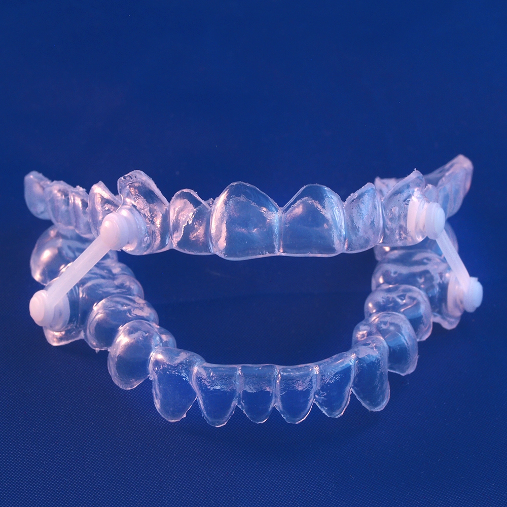Invisalign-shaped sleep apnea appliance holding upper and lower jaw closed, blue background.