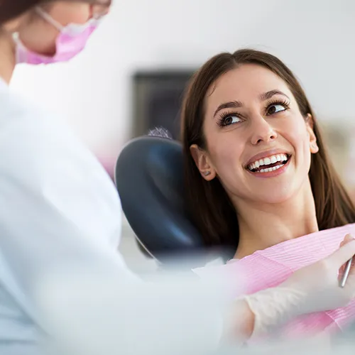 woman smiling up at the dentist