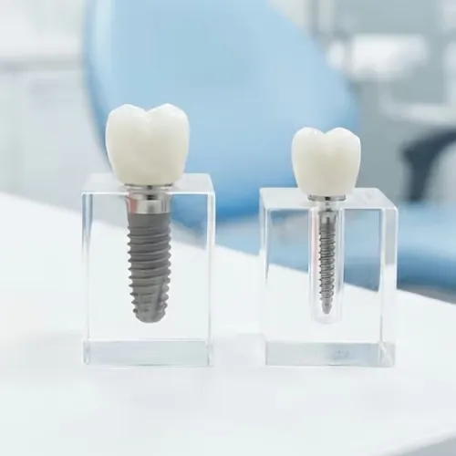 Dental implant beside mini dental implant on white surface.
